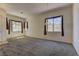 Large living room with neutral carpeting, natural light from ample windows, and an inviting atmosphere at 1945 Trail Peak Ln, Las Vegas, NV 89134