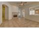 Open-concept living space featuring tile floors, a fireplace, and an archway leading to the kitchen area at 1945 Trail Peak Ln, Las Vegas, NV 89134
