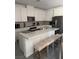 Well-lit kitchen features an island with seating and stainless steel appliances at 219 Vanhoy Ave, Henderson, NV 89011