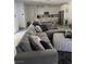 Comfortable living room featuring a sectional sofa with throw pillows and modern decor at 219 Vanhoy Ave, Henderson, NV 89011