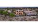 An eye-level aerial view showcases the backyard pool and patio of this stunning home, surrounded by desert landscaping at 2369 Green Mountain Ct, Las Vegas, NV 89135