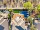 Overhead shot of a stunning backyard featuring a modern pool, spa, lawn, lounge area and a fire pit at 2369 Green Mountain Ct, Las Vegas, NV 89135