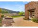 Backyard oasis featuring a modern fire pit, desert landscaping, and mountain views at 2369 Green Mountain Ct, Las Vegas, NV 89135