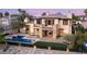 Luxury home showcasing a stunning pool, patio, and landscaped backyard, perfect for outdoor entertaining and relaxation at 2369 Green Mountain Ct, Las Vegas, NV 89135
