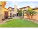 Exterior shot showcasing the manicured lawn, desert landscaping, and stone accents at 2369 Green Mountain Ct, Las Vegas, NV 89135