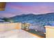 Scenic mountain views from the cozy balcony with glass railings provide a perfect place for relaxation and enjoying the scenery at 2369 Green Mountain Ct, Las Vegas, NV 89135