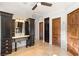 A Primary bathroom featuring dark wood cabinets, marble countertops, and matching and doors at 2369 Green Mountain Ct, Las Vegas, NV 89135