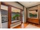 Bedroom with hardwood floors, a dresser, and large windows offering picturesque views of the surrounding mountains at 2369 Green Mountain Ct, Las Vegas, NV 89135
