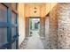 Grand foyer with stone accent wall, decorative pendant, and custom front door at 2369 Green Mountain Ct, Las Vegas, NV 89135