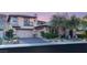 View of a well-manicured front yard and a three car garage at 2369 Green Mountain Ct, Las Vegas, NV 89135