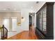 Upstairs hallway featuring hardwood floors, white trim, and a black cabinet with glass doors at 2369 Green Mountain Ct, Las Vegas, NV 89135
