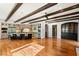 Spacious kitchen with hardwood floors, island with seating, and exposed beam ceiling at 2369 Green Mountain Ct, Las Vegas, NV 89135