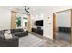 Cozy media room with dark gray couch and a large screen television at 2369 Green Mountain Ct, Las Vegas, NV 89135
