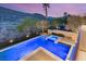 A stunning pool and spa with stone accents are nestled in a picturesque backyard with mountain views at 2369 Green Mountain Ct, Las Vegas, NV 89135