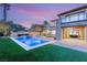 A luxurious backyard oasis features a pool with a spa, stone accents, and manicured landscaping, perfect for relaxation at 2369 Green Mountain Ct, Las Vegas, NV 89135