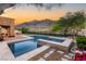 Beautiful pool and spa combination with stone accents, landscaping, and mountain views at 2369 Green Mountain Ct, Las Vegas, NV 89135