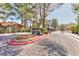 A picturesque neighborhood entrance featuring mature trees and landscaping at 2405 Pickwick Dr # 55, Henderson, NV 89014
