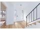 Bright foyer with modern wood flooring, crisp white walls, and staircase, creating a welcoming and stylish entrance at 2405 Pickwick Dr # 55, Henderson, NV 89014