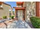 Inviting home exterior featuring a well-kept yard, stucco facade, and charming front entrance with security gate and address number at 2405 Pickwick Dr # 55, Henderson, NV 89014