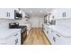 Bright kitchen features stainless steel appliances, white marble countertops and cabinets at 2405 Pickwick Dr # 55, Henderson, NV 89014