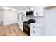 Well-lit kitchen featuring white cabinets, black hardware, and stainless steel appliances at 2405 Pickwick Dr # 55, Henderson, NV 89014