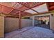 A covered patio area featuring concrete flooring and partial brick and stucco walls at 2405 Pickwick Dr # 55, Henderson, NV 89014