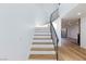 Elegant staircase featuring modern railing and wood stairs leading to upper level at 2405 Pickwick Dr # 55, Henderson, NV 89014