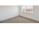 Bright bedroom features neutral carpet, white walls, and a window letting in natural light at 250 Shadybrook Ln # D, Las Vegas, NV 89107