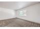 Bright bedroom features neutral carpet, white walls, and a window letting in natural light at 250 Shadybrook Ln # D, Las Vegas, NV 89107