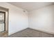Bright bedroom featuring neutral carpet, white walls, and an adjacent laundry closet for added convenience at 250 Shadybrook Ln # D, Las Vegas, NV 89107