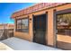 Second-story unit featuring a secure metal security door, adjacent to the sliding glass door to the patio at 250 Shadybrook Ln # D, Las Vegas, NV 89107
