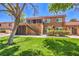 Well-maintained two-story townhouse with manicured landscaping, staircase, and charming red tile roof at 250 Shadybrook Ln # D, Las Vegas, NV 89107