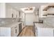 Beautiful kitchen with stainless steel appliances, white cabinetry, and stone countertops at 250 Shadybrook Ln # D, Las Vegas, NV 89107