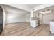 Large open-concept living and kitchen area with modern finishes and wood floors at 250 Shadybrook Ln # D, Las Vegas, NV 89107