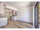 Bright living area featuring an open layout to the kitchen and hardwood floors at 250 Shadybrook Ln # D, Las Vegas, NV 89107