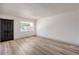 Bright living room featuring wood flooring, a window, and neutral wall color at 250 Shadybrook Ln # D, Las Vegas, NV 89107