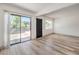 Living room has wood flooring and access to a patio and front door at 250 Shadybrook Ln # D, Las Vegas, NV 89107