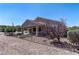 Backyard featuring decorative rock, minimal lawn and covered patio in neutral hues at 2538 Capella Star St, Henderson, NV 89044