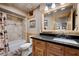 Bathroom featuring a vanity, bathtub, and shower with a log-framed mirror at 274 Ski Trail Rd, Mount Charleston, NV 89124