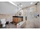 Modern bathroom with glass enclosed shower, stone tile, and wood vanity at 274 Ski Trail Rd, Mount Charleston, NV 89124