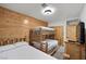 Bedroom with rustic bunk beds, matching twin, wood walls, and neutral carpeting at 274 Ski Trail Rd, Mount Charleston, NV 89124