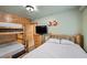Rustic bedroom with twin log beds, wood-paneled accent wall, and themed decor at 274 Ski Trail Rd, Mount Charleston, NV 89124