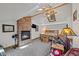 Comfortable bedroom with stone fireplace, skylight, ceiling fan, and log-style furniture at 274 Ski Trail Rd, Mount Charleston, NV 89124