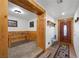 Inviting entryway featuring beautiful wood accents, a foosball table room and a glimpse of the ornate front door at 274 Ski Trail Rd, Mount Charleston, NV 89124