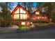 Stunning log home featuring a large deck, ample windows, and beautiful landscaping at 274 Ski Trail Rd, Mount Charleston, NV 89124