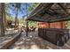 Inviting hot tub nestled in a gazebo, surrounded by stone landscaping and picturesque views of the backyard at 274 Ski Trail Rd, Mount Charleston, NV 89124