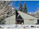 Mt. Charleston Library in a snowy scene, featuring an American flag and mountain backdrop at 274 Ski Trail Rd, Mount Charleston, NV 89124