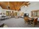 Expansive living area with a stone fireplace, large windows, and comfortable seating at 274 Ski Trail Rd, Mount Charleston, NV 89124