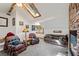 Cozy living room with rustic decor, a skylight, and a stone fireplace at 274 Ski Trail Rd, Mount Charleston, NV 89124