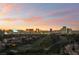 Expansive aerial view of the Las Vegas area with golf course and colorful sunset at 3111 Bel Air Dr # 12E, Las Vegas, NV 89109